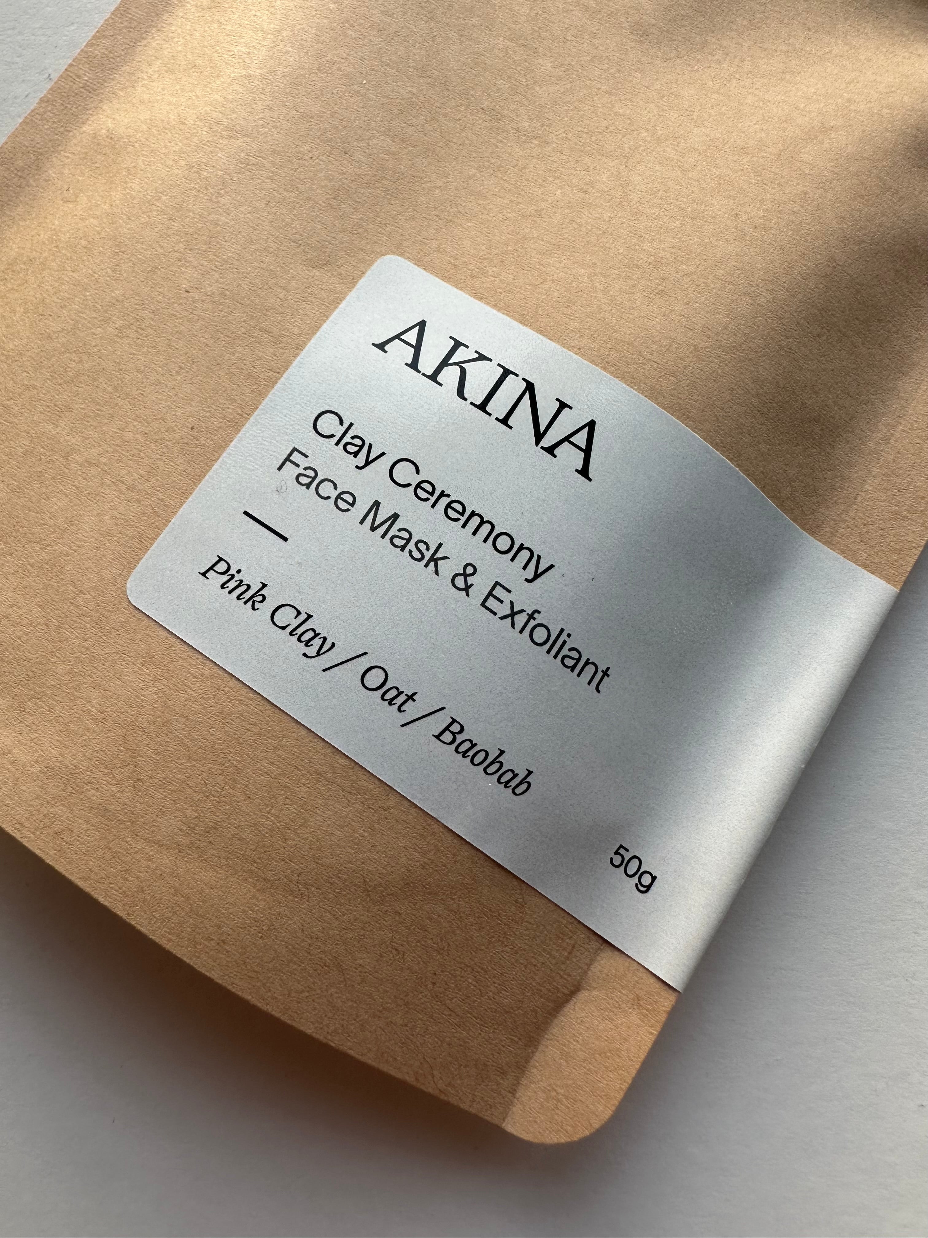 AKINA Clay Ceremony face mask and exfoliant in kraft paper packaging with label